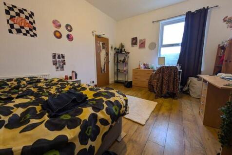 A vibrant and inviting double bedroom with ampl...