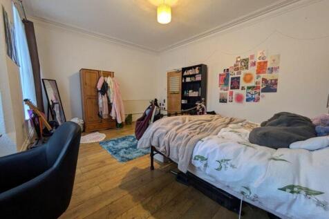 A spacious and inviting double bedroom, featuri...