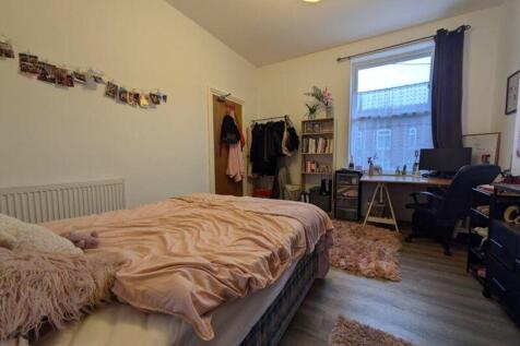 A cozy and inviting double bedroom with natural...