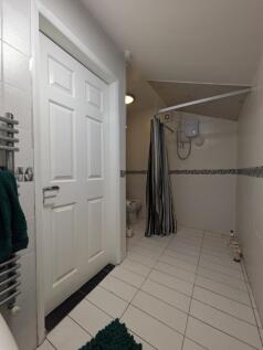 A clean and functional bathroom featuring a sho...