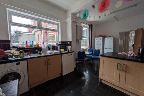 A spacious kitchen with ample storage and natur...