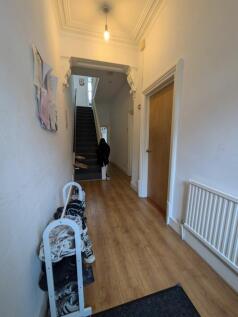 A spacious and inviting hallway with natural li...