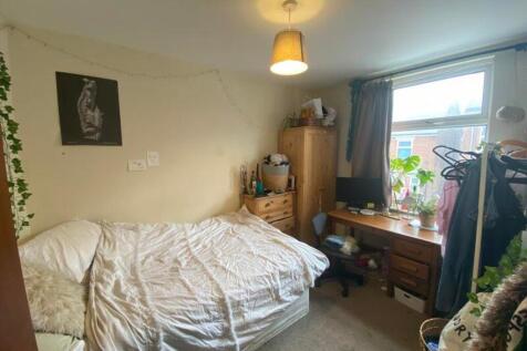 A cozy and well-lit double bedroom with ample s...
