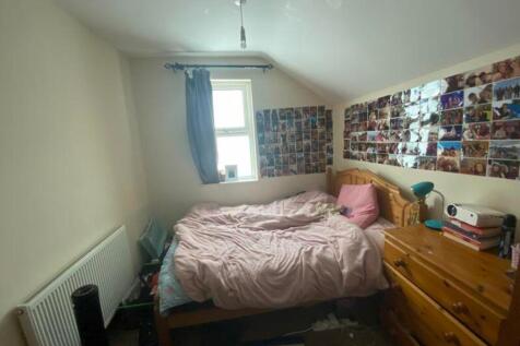 A cozy double bedroom with personal touches and...