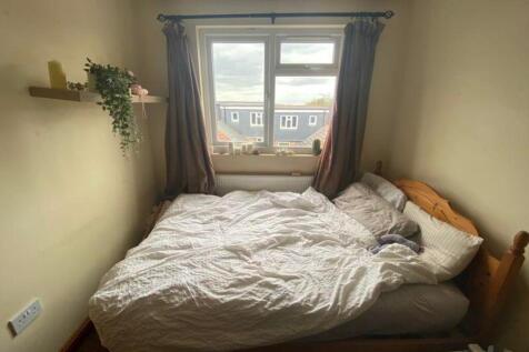 A cozy double bedroom with natural light and a ...