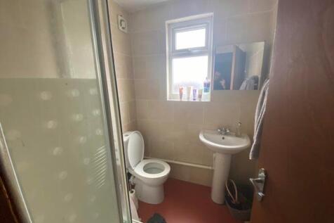 A functional bathroom with natural light, featu...