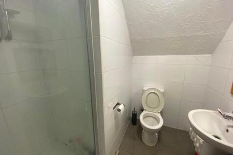 A well-maintained bathroom featuring a shower, ...