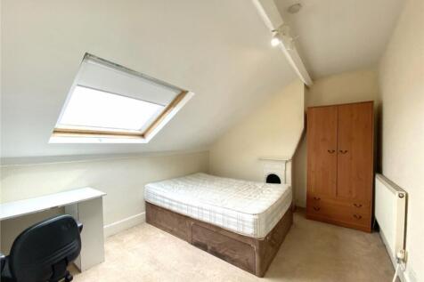 This cozy double bedroom features a comfortable...