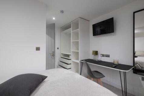 A bright and modern double bedroom featuring a ...