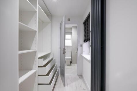 A bright and tidy hallway featuring modern shel...