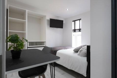 A bright and modern double bedroom featuring am...