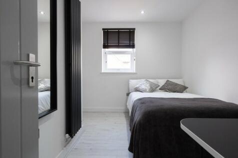 A bright and tidy double bedroom featuring mode...