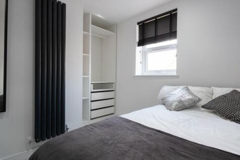 A bright and modern double bedroom featuring a ...