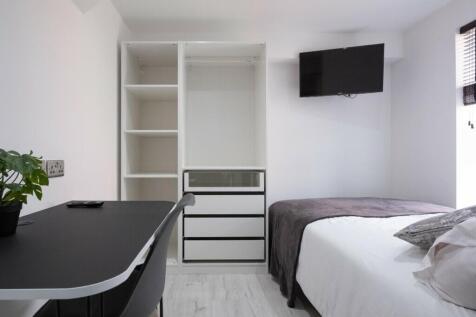 A bright and modern double bedroom featuring a ...