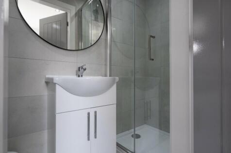 A modern and sleek bathroom featuring a stylish...