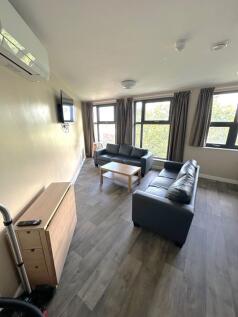 A bright and spacious living room featuring lar...