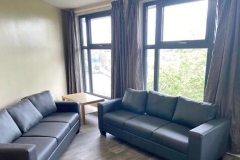 A bright and spacious living room, featuring la...