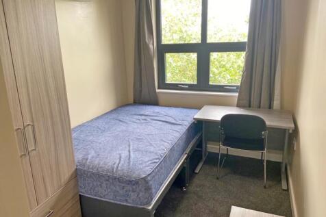 This cozy double bedroom features a comfortable...