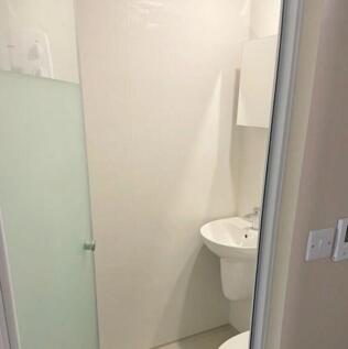 A modern and clean bathroom featuring a shower,...