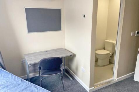 This cozy space features a practical desk and c...