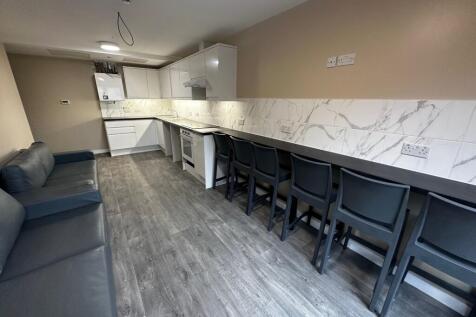 A modern kitchen featuring sleek cabinetry and ...