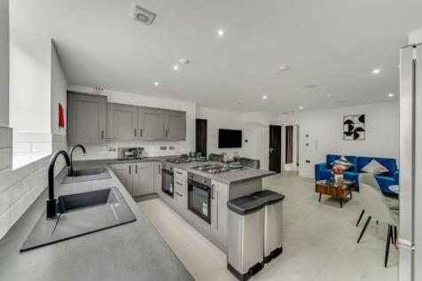 A modern and spacious kitchen area with ample n...