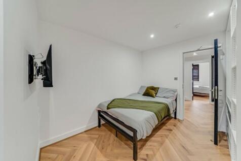 A spacious and modern double bedroom featuring ...