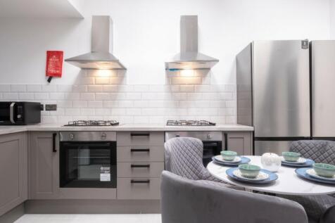 A modern and tidy kitchenette with stylish appl...