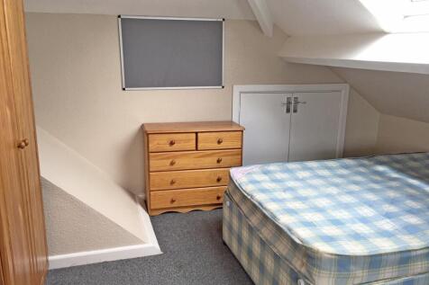 Cozy double bedroom featuring a comfortable bed...