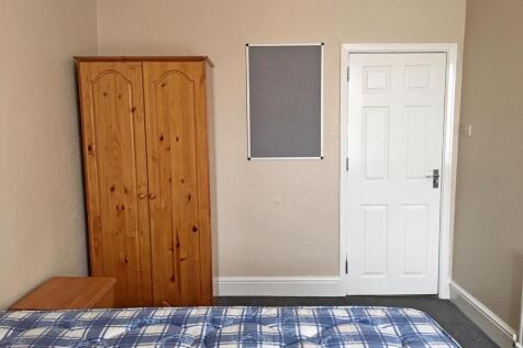 Spacious double bedroom featuring a comfortable...