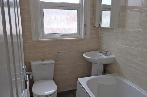 A well-maintained bathroom featuring a bath, si...