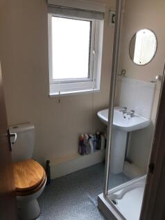 This well-maintained bathroom features a modern...
