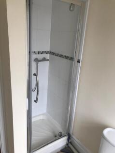 A modern bathroom featuring a sleek shower encl...