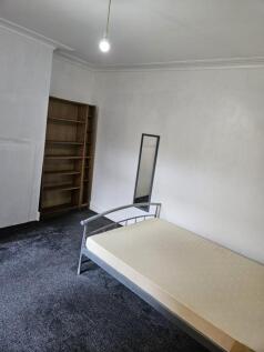 A spacious double bedroom featuring a large fit...