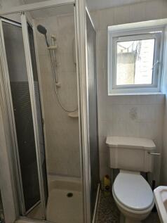 A modern bathroom featuring a sleek shower encl...