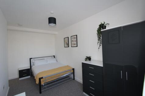 A stylish double bedroom featuring a comfortabl...