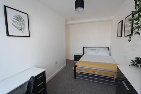 Bright and spacious double bedroom featuring a ...