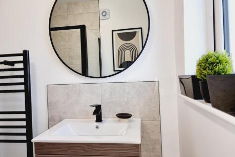 A beautifully designed bathroom featuring a sle...