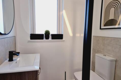 A modern bathroom featuring a sleek design with...