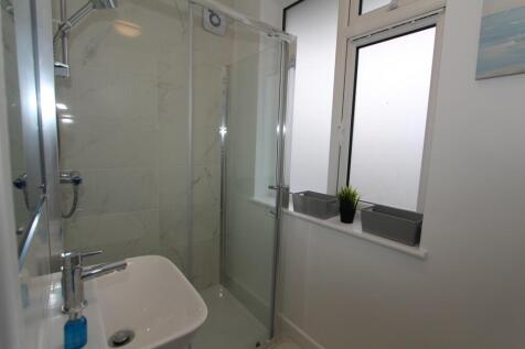 A modern bathroom featuring a sleek shower encl...