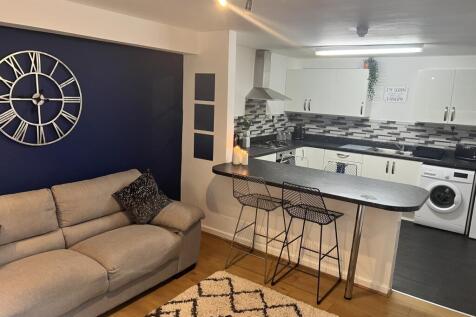 A modern living room featuring a stylish sofa a...
