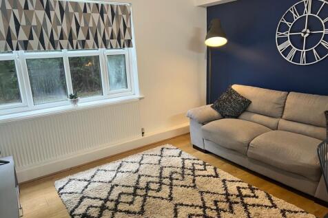 A cozy living room featuring a stylish gray sof...