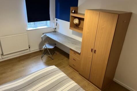 This inviting double bedroom features a cozy at...