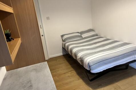 This cozy double bedroom features a comfortable...