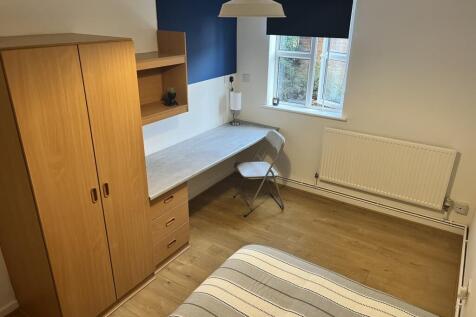 This charming double bedroom features a cozy la...