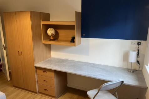 This cozy double bedroom features ample storage...