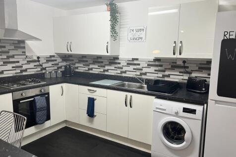 Modern kitchen featuring sleek cabinetry and co...