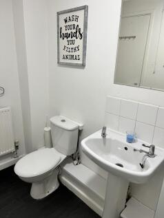 A well-maintained bathroom featuring modern fix...