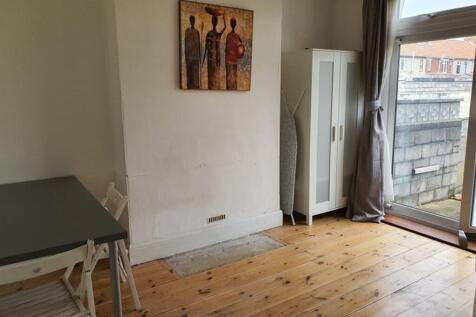 A cozy living room featuring warm wooden floors...