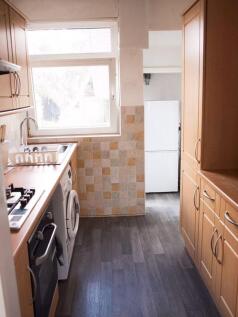 This charming kitchen features ample cabinetry ...